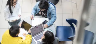 Aerial photo of UBCO students collaborating around a table.