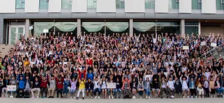 Students seated on the steps of Orchard Commons for group photo on Imagine Day