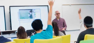 A student raises his hand in class