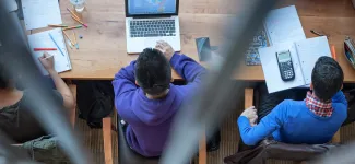 Overhead view of students studying at a desk